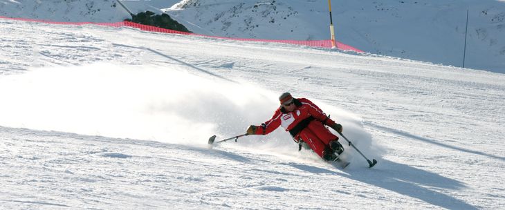 An experienced skier with a disability using stablios 